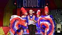 CIRQUE - The Greatest Show performers including a gentleman juggling as he is surrounded by admiring ladies