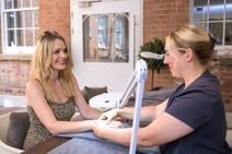 Woman getting a nail and hand treatment