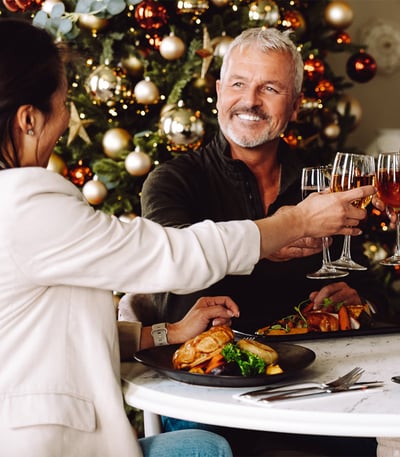 Couple enjoying a festive meal with wine