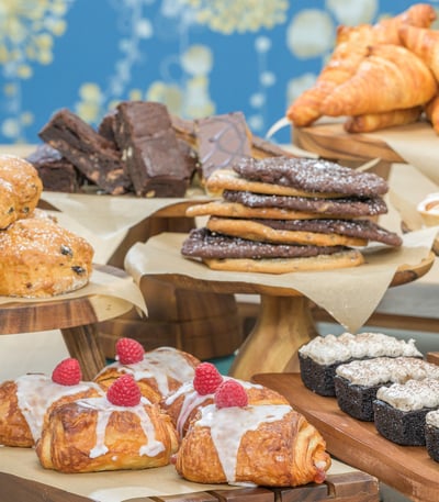 A beautifully arranged table filled with an assortment of delicious pastries at The Coffee Nest, Heythrop Park.