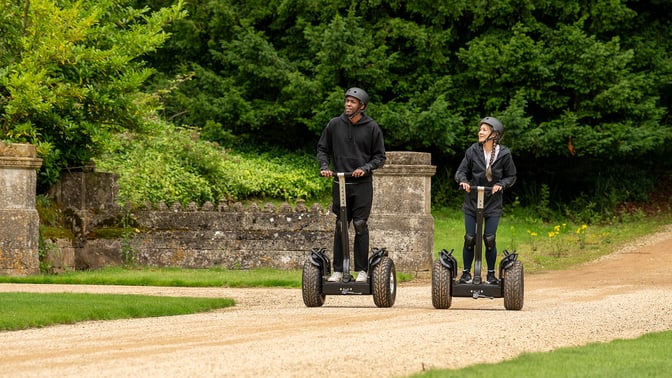 Guests riding around the hotel grounds on segways at Heythrop Park Hotel