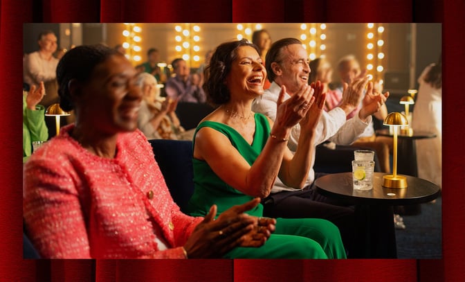 Angie and Mick clapping as they enjoy the incredible entertainment only found at a Warner Hotel