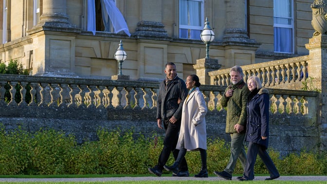 two couples walking with coats on, enjoying the gardens