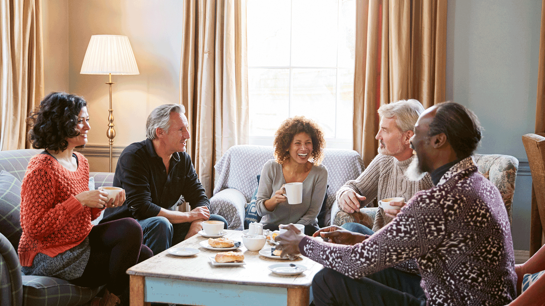 A group of guests at a Warner Hotel enjoying time together over a drink